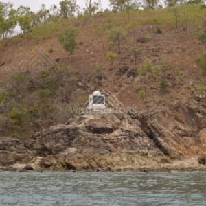 Captain Cook Monument on a Rocky Island Shoreline. Possession Island, Australia.