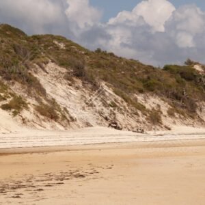 Eroded dune face above a quiet stretch of sand. Elim Beach, Australia.