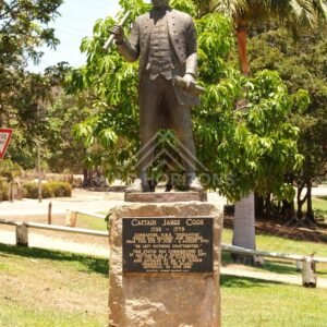 Captain James Cook statue and plaque in a tropical park setting. Cooktown, Australia.