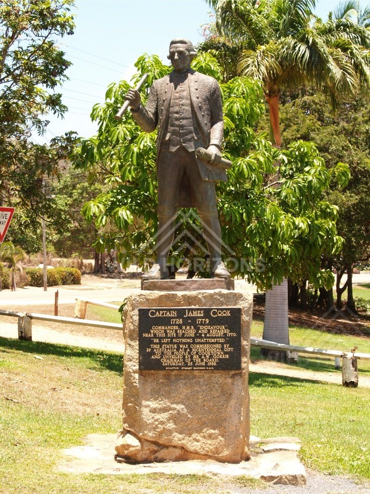 Captain James Cook statue and plaque in a tropical park setting. Cooktown, Australia.