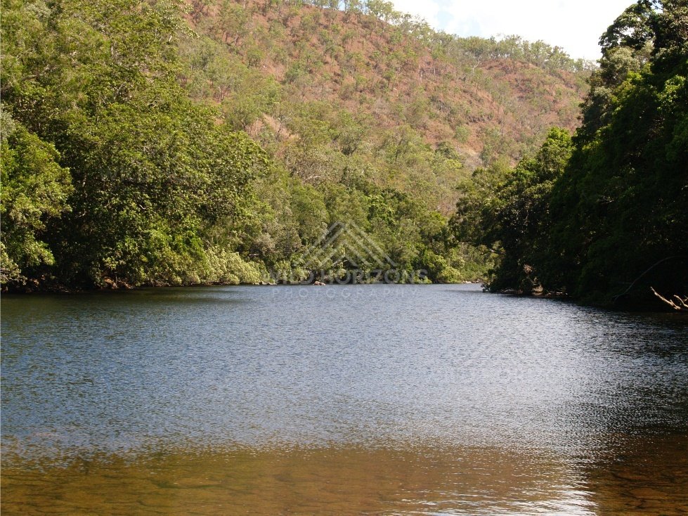 Calm reach of the Bloomfield River bordered by rainforest. Bloomfield River, Australia.