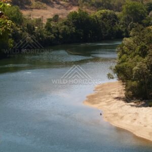 Sandy bend of the Bloomfield River beneath forested hills. Bloomfield River, Australia.