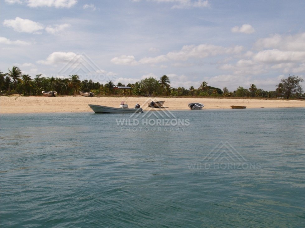Small boats anchored off a sandy tropical beach. Seisia, Queensland, Australia.