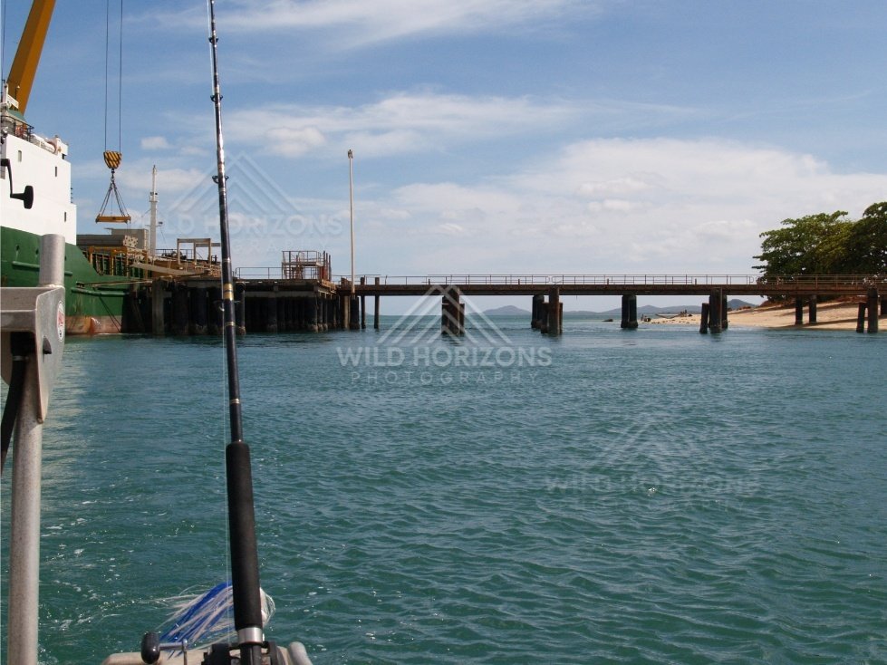 Wharf and ship scene viewed from a small fishing boat. Seisia, Queensland, Australia.