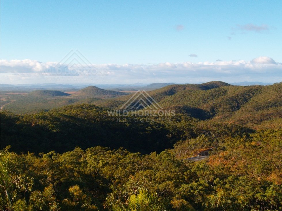 Lookout over green hills and valleys with scattered cloud shadows. Queensland, Australia.