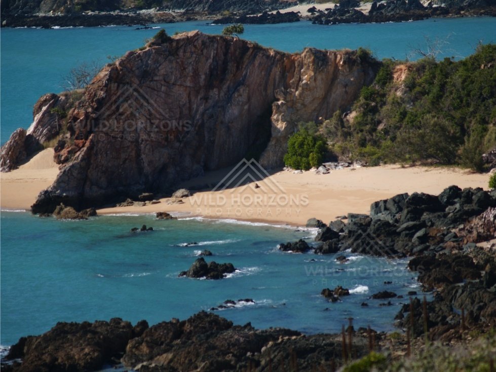 Rocky coastal cliffs above clear sea. Stanage Bay, Australia.