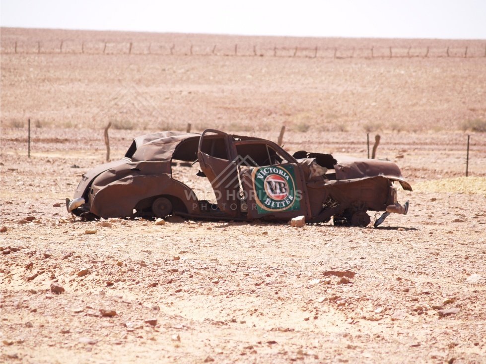 Abandoned rusted car wreck in an arid landscape. Birdsville Region, Australia.