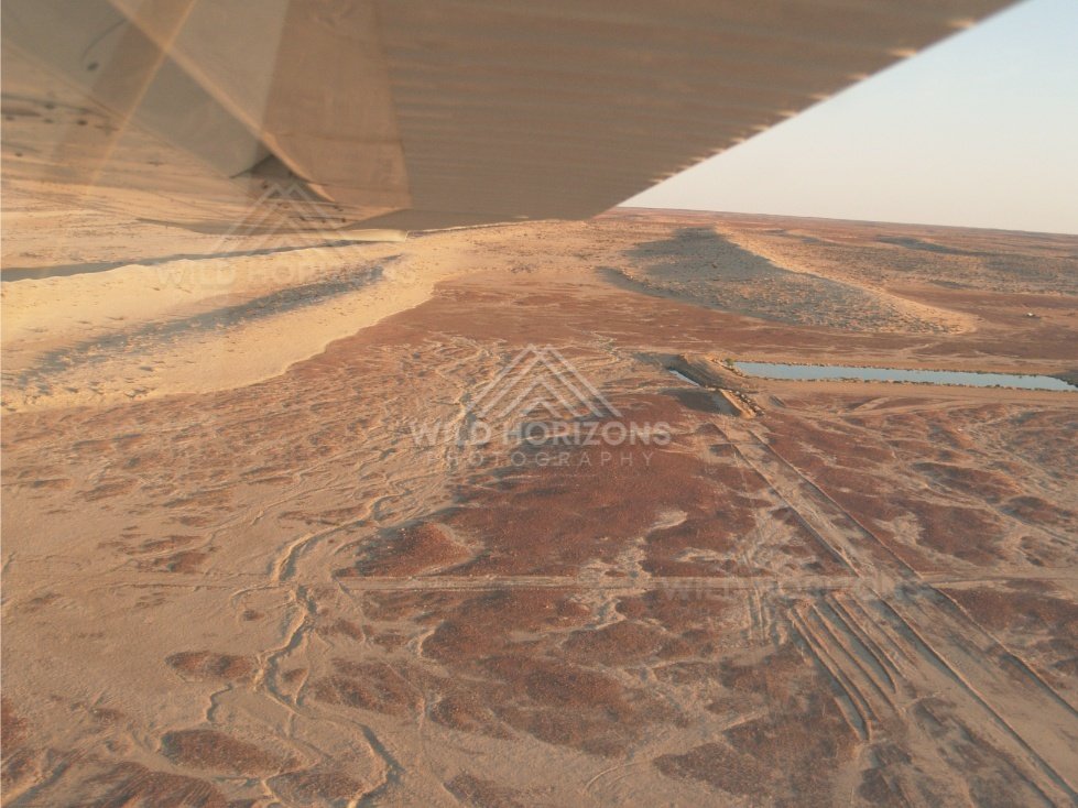 Aerial view across expansive red desert plains. Simpson Desert, Australia.