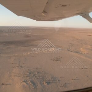 Desert plains seen through aircraft window. Simpson Desert, Australia.