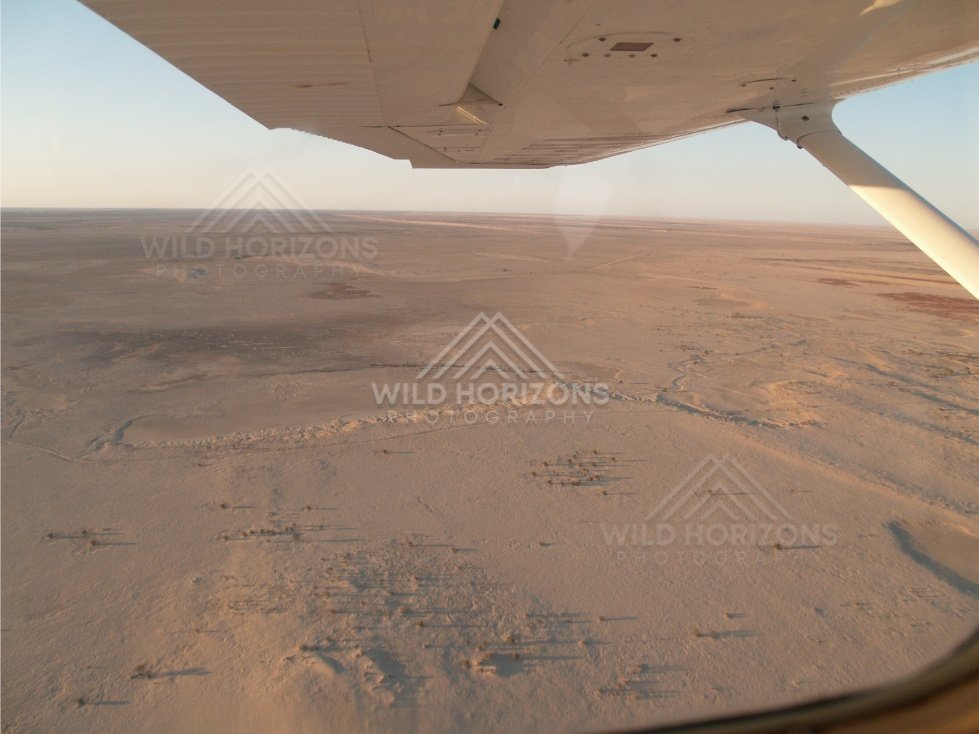 Desert plains seen through aircraft window. Simpson Desert, Australia.