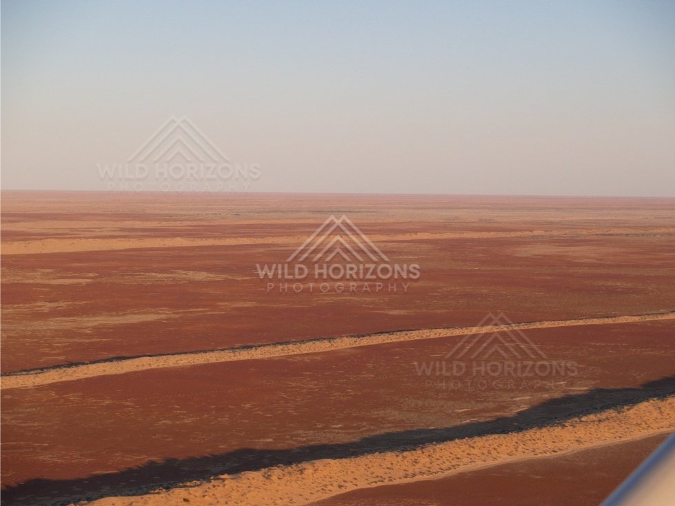 Flat desert expanse with salt patches. Simpson Desert, Australia.