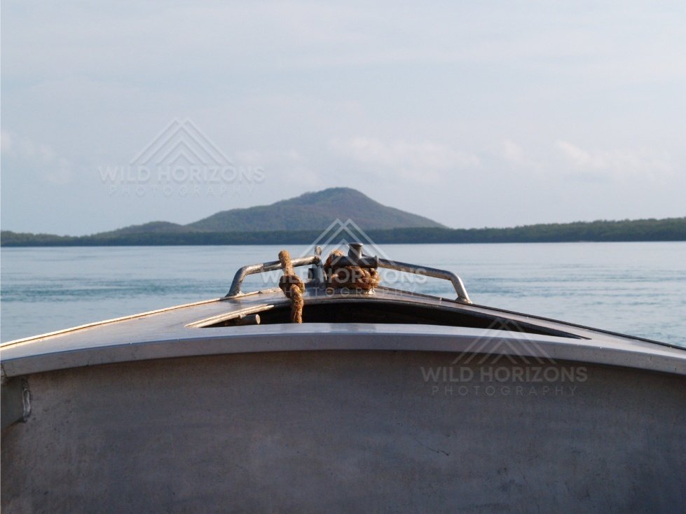 View from a small boat toward a low island on the horizon. Cape York, Queensland, Australia.