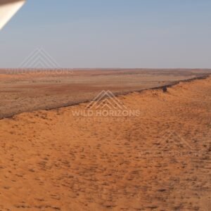 Dune ridge beneath aircraft wing. Simpson Desert, Australia.