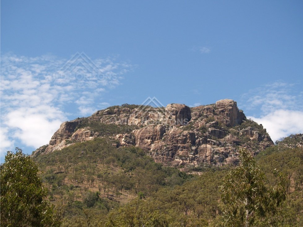 Rugged mountain rising above forest. Queensland, Australia.