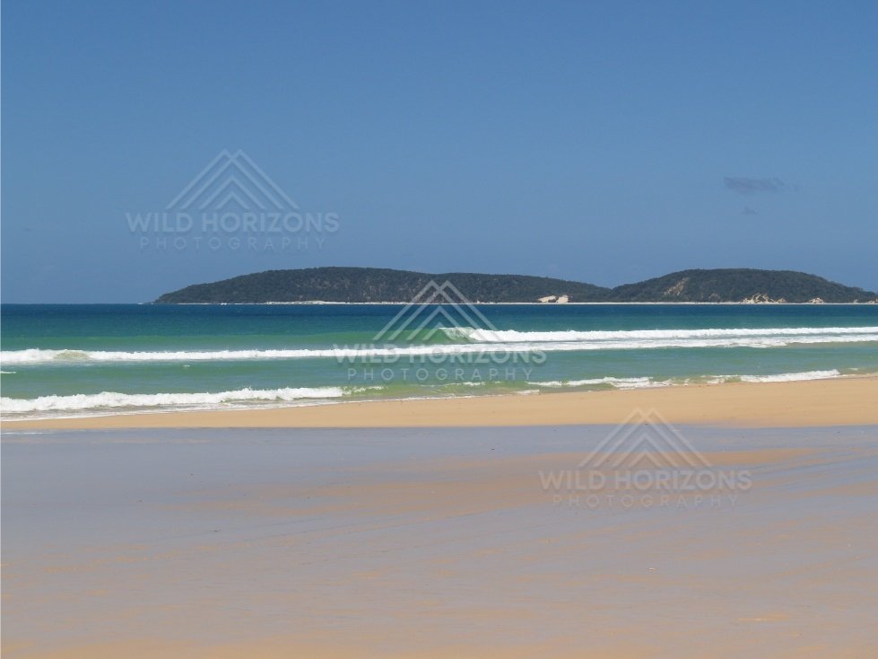 Wet beach looking to Double Island Point. Queensland, Australia.