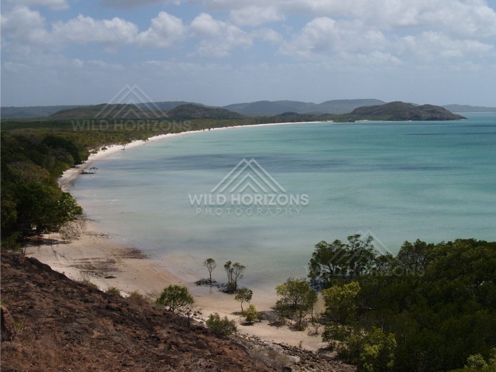 Sheltered Bay with Pale Sand Beach and an Offshore Headland. Cape York, Australia.