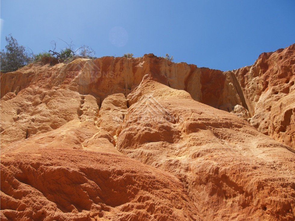 Sunlit sandstone wall at Rainbow Beach. Australia.