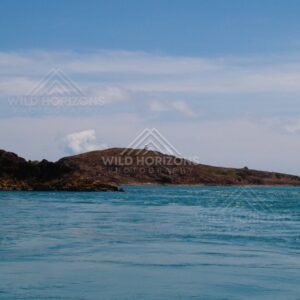 Dark headland shoreline viewed from water. Cape York, Queensland, Australia.