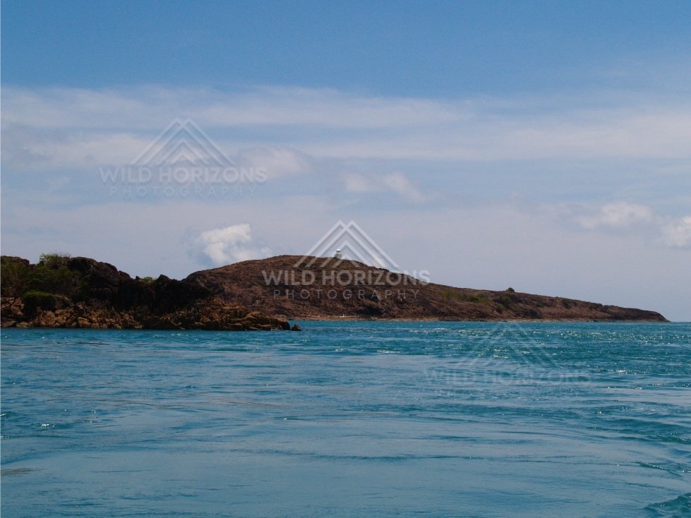 Dark headland shoreline viewed from water. Cape York, Queensland, Australia.
