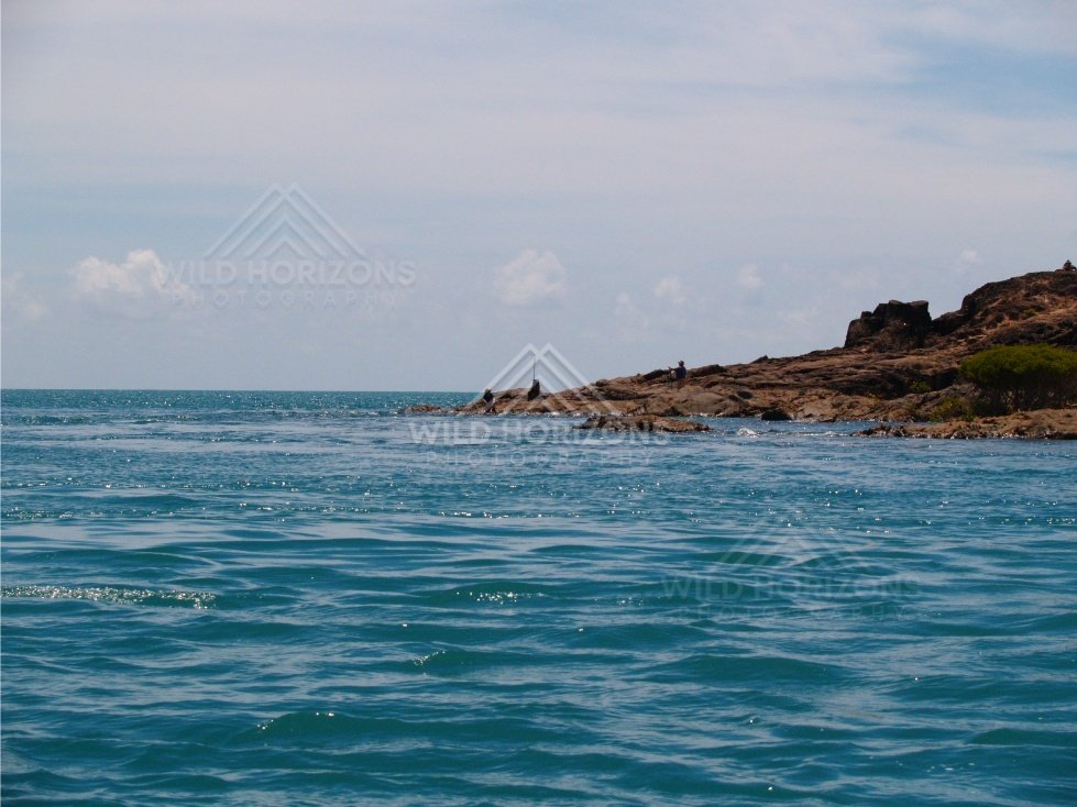Low rocky coast with light surf. Cape York, Queensland, Australia.
