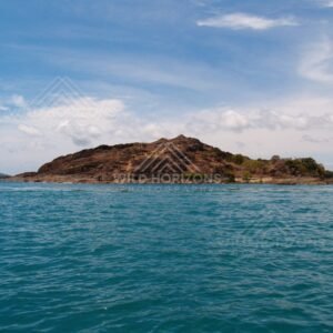 Rugged island with layered rock faces. Cape York, Queensland, Australia.