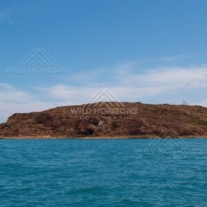 Large rocky island across deep blue water. Cape York, Queensland, Australia.