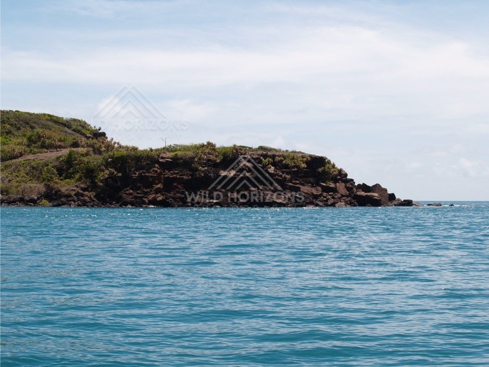 Cliffed shoreline with trees above the ocean. Cape York, Queensland, Australia.