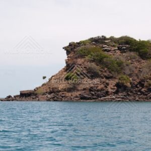 Steep rocky point rising from the sea. Cape York, Queensland, Australia.