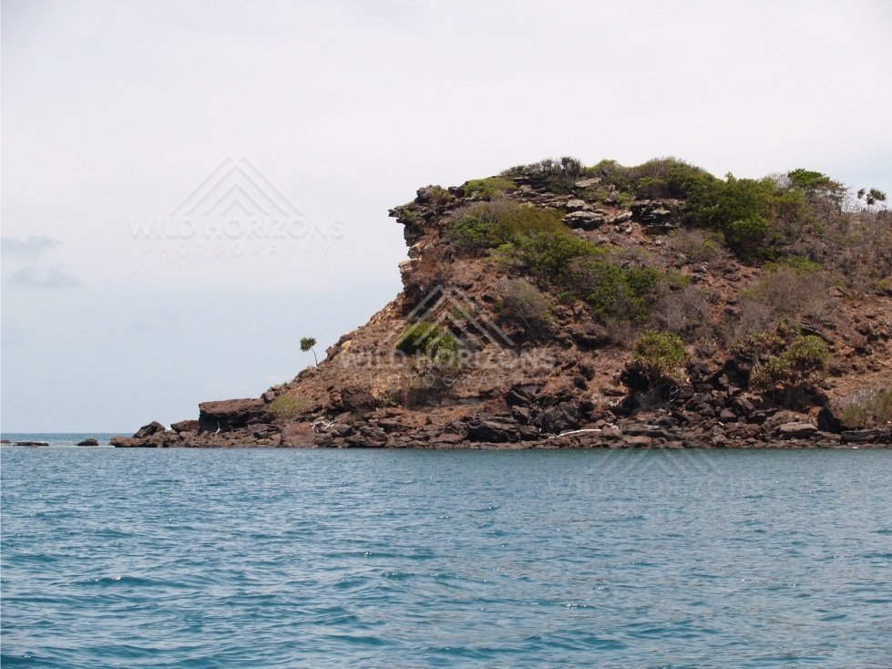 Steep rocky point rising from the sea. Cape York, Queensland, Australia.