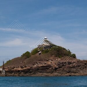 Small rocky island with a navigation marker. Cape York, Queensland, Australia.