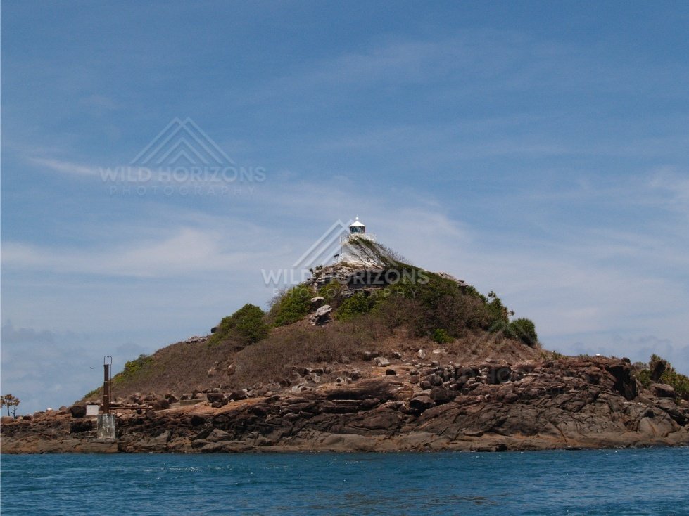 Small rocky island with a navigation marker. Cape York, Queensland, Australia.