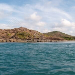 Rugged coastal hills seen across choppy water. Cape York, Queensland, Australia.