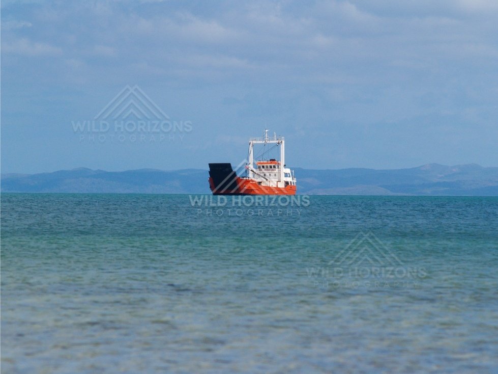 Small commercial vessel travelling across open sea. Seisia, Queensland, Australia.