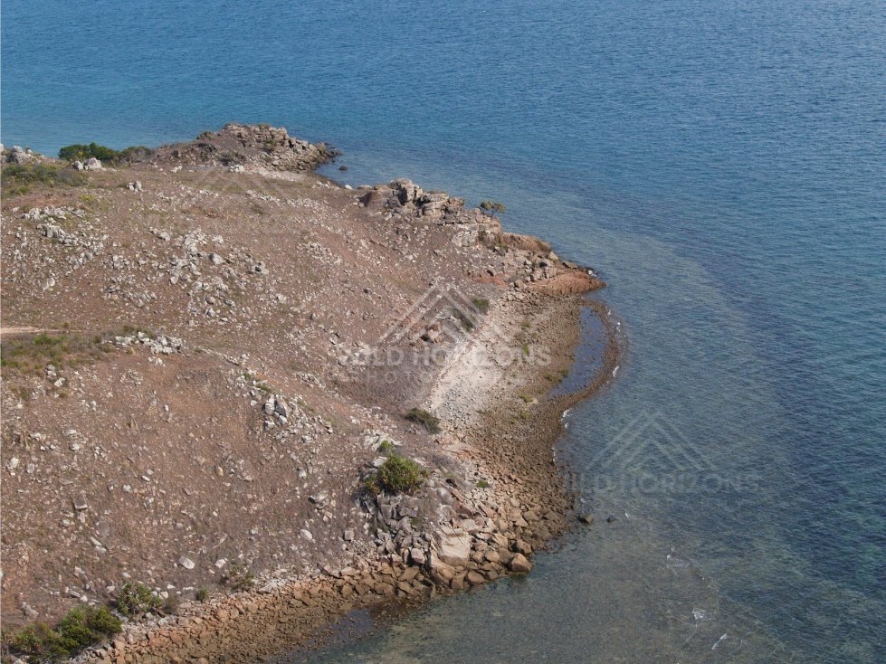 Rocky shoreline and clear water viewed from above. Thursday Island, Queensland, Australia.