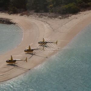 Line of helicopters on curved sandbar and lagoon. Thursday Island, Queensland, Australia.