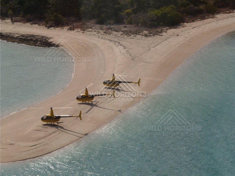 Line of helicopters on curved sandbar and lagoon. Thursday Island, Queensland, Australia.