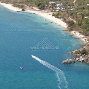 Curving beach and forested headland from the air. Thursday Island, Queensland, Australia.